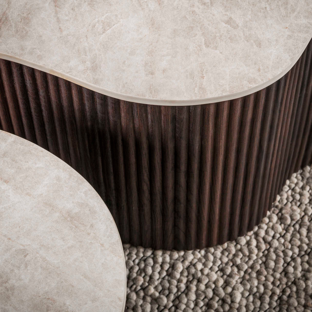 Set of 2 organic Cruz Grand coffee tables with Taj Mahal ceramic tops and dark brown ribbed base.