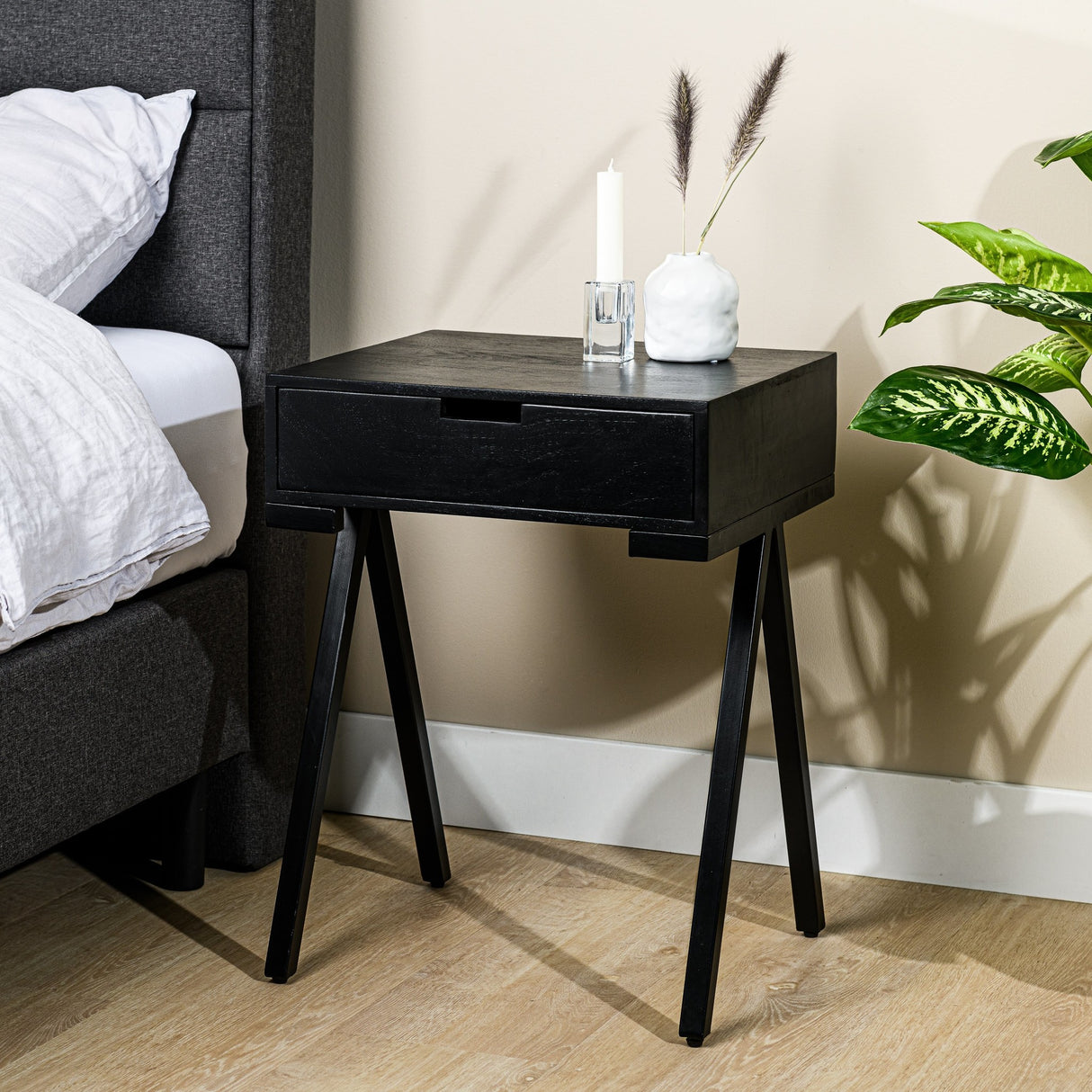 Bedside table Joey DH Interior Black Mango wood Atmospheric photo diagonal front view