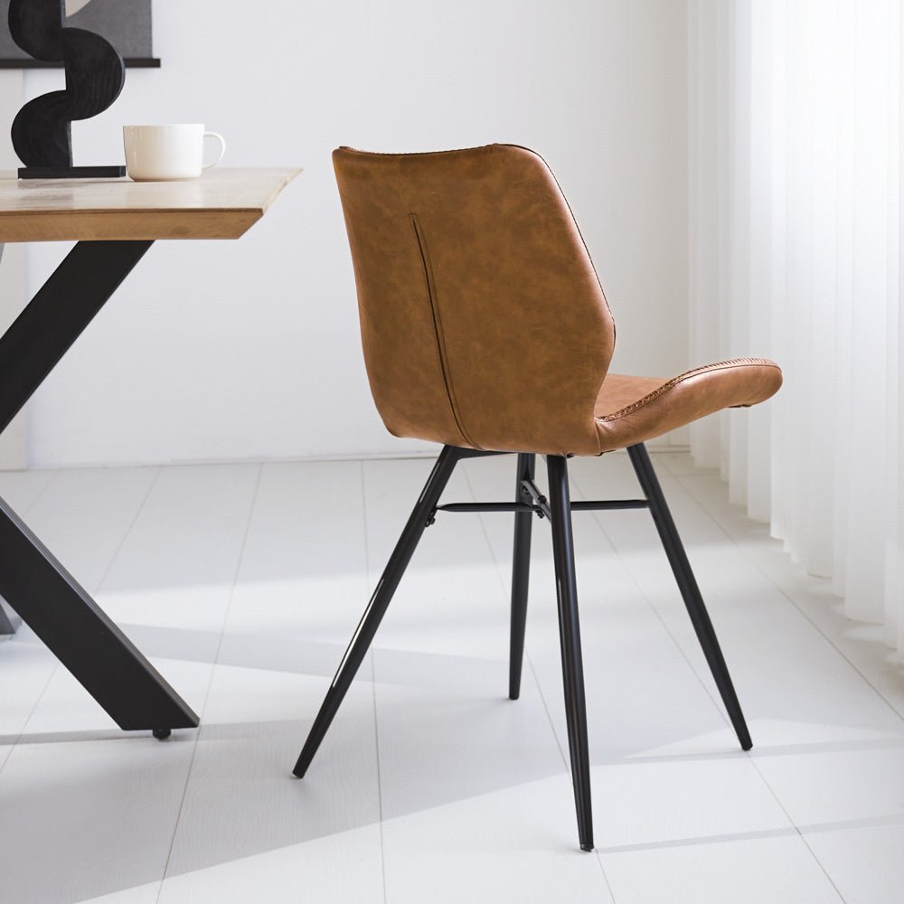 Dining room chair Beau artificial leather Dimehouse Cognac LxWxH 72x68x50 Faux leather Atmospheric photo diagonal rear view