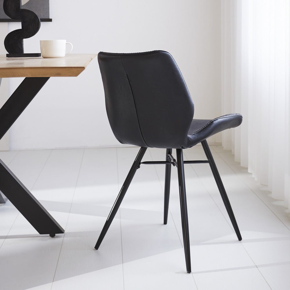 Dining room chair Beau artificial leather Dimehouse Black LxWxH 72x68x50 Faux leather Atmospheric photo diagonal rear view