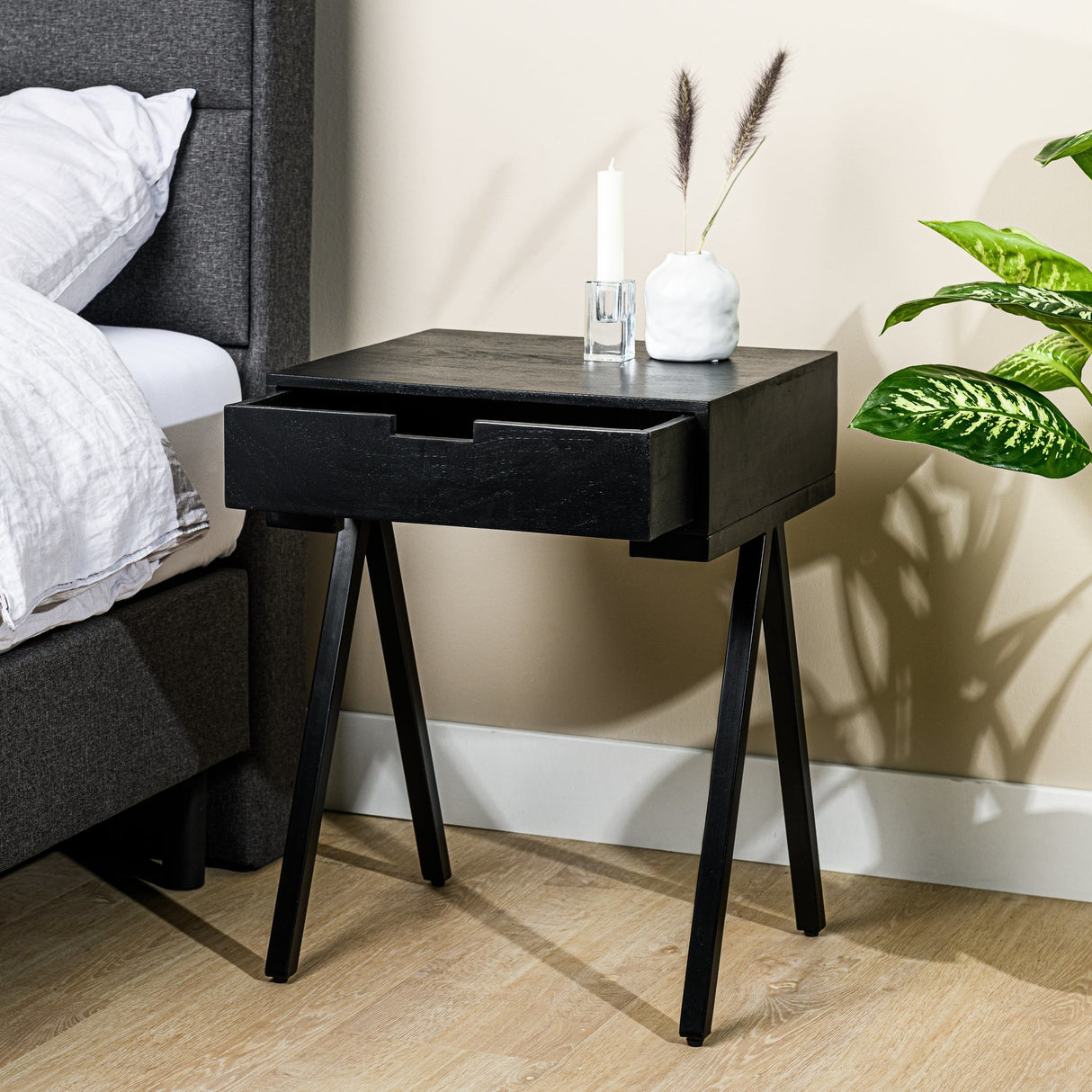 Bedside table Joey DH Interior Black Mango wood Atmospheric photo diagonal front view