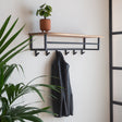 Coat rack Niels DH Interior Acacia LxWxH 102x37x30 Acacia wood Atmospheric photo diagonal front view